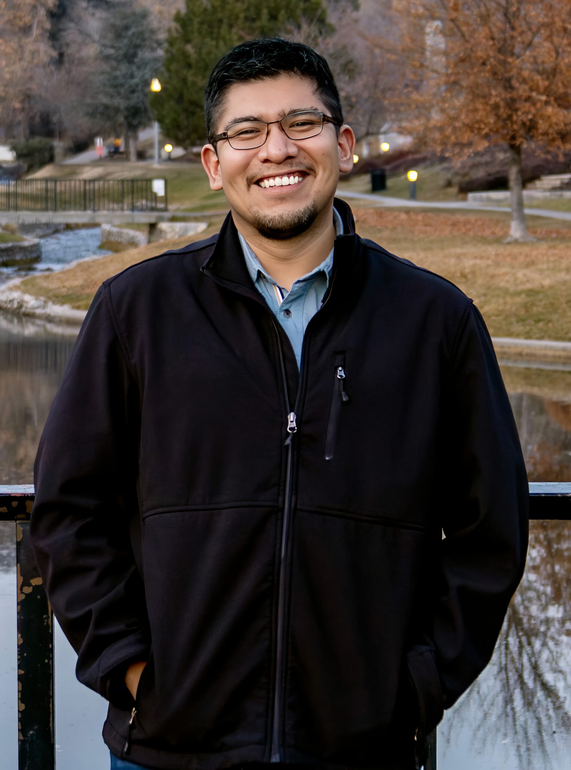 Christian Najera standing by lake