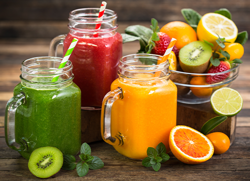 Several fruit juices on a wooden table